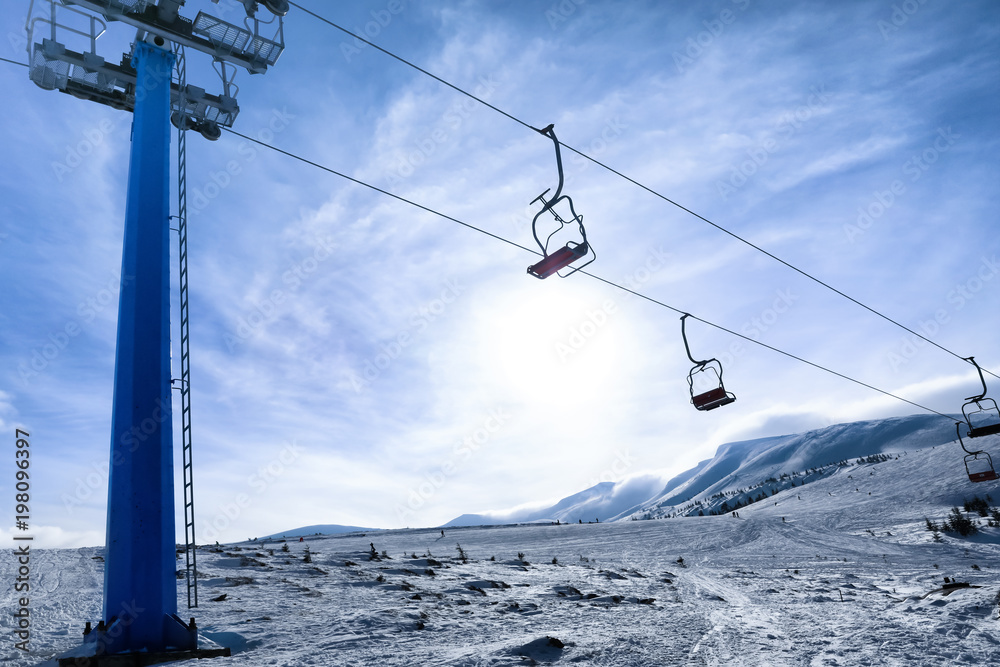 Ski lift at snowy resort. Winter vacation