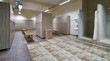 © Gecko Studio - Public shower interior with everal showers, toilet sink and lockers in locker room in luxury fitness spa centre