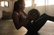 © Jacob Lund - Determined woman exercising with medicine ball in gym