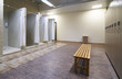 © Gecko Studio - Public shower interior with everal showers and lockers in locker room in luxury fitness spa centre