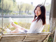 © atiger - Portrait of asian girl student in school uniform japanese style, sitting on swing and enjoy herself in windy and sunny day.
