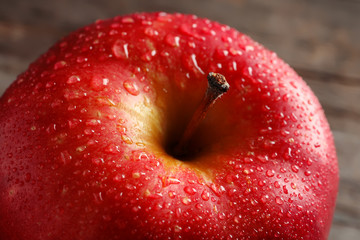 Ripe red apple with water drops, closeup