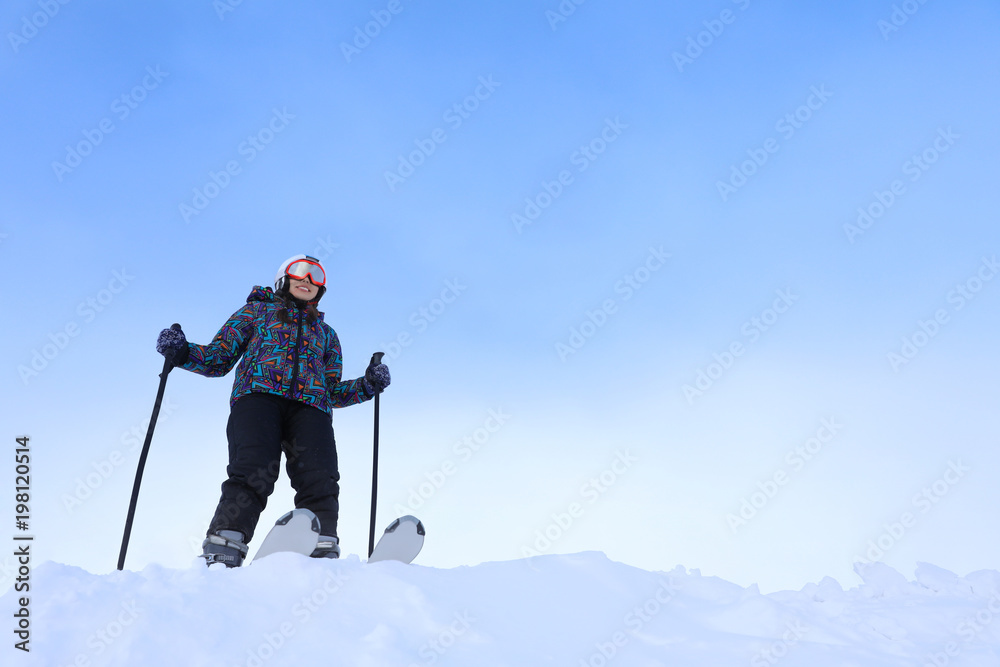 Woman skiing at snowy resort. Winter vacation