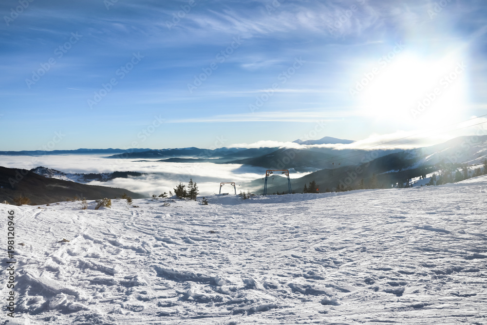 Ski slope at snowy resort on winter day
