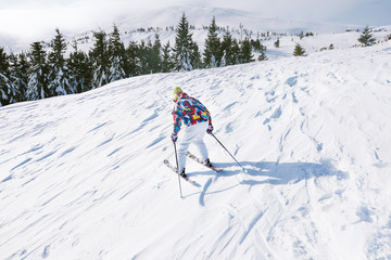 Wall Mural - Woman skiing on piste at snowy resort. Winter vacation