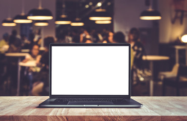 Wall Mural - Modern computer,laptop on counter bar with blur cafe,restaurant
