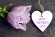 Happy Mother's Day.Pink tulip flower and decorative heart on old wooden background.
