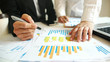© fgnopporn - Business people working together discussing plans and discussing financial diagram, Teamwork, Success