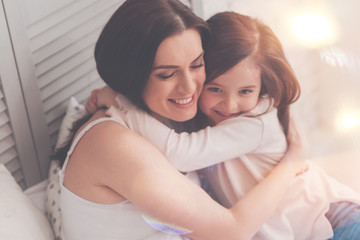 Wall Mural - My precious gift. Sweet loving admirable mother and daughter sharing an emotional moment expressing their feelings while enjoying the morning at home