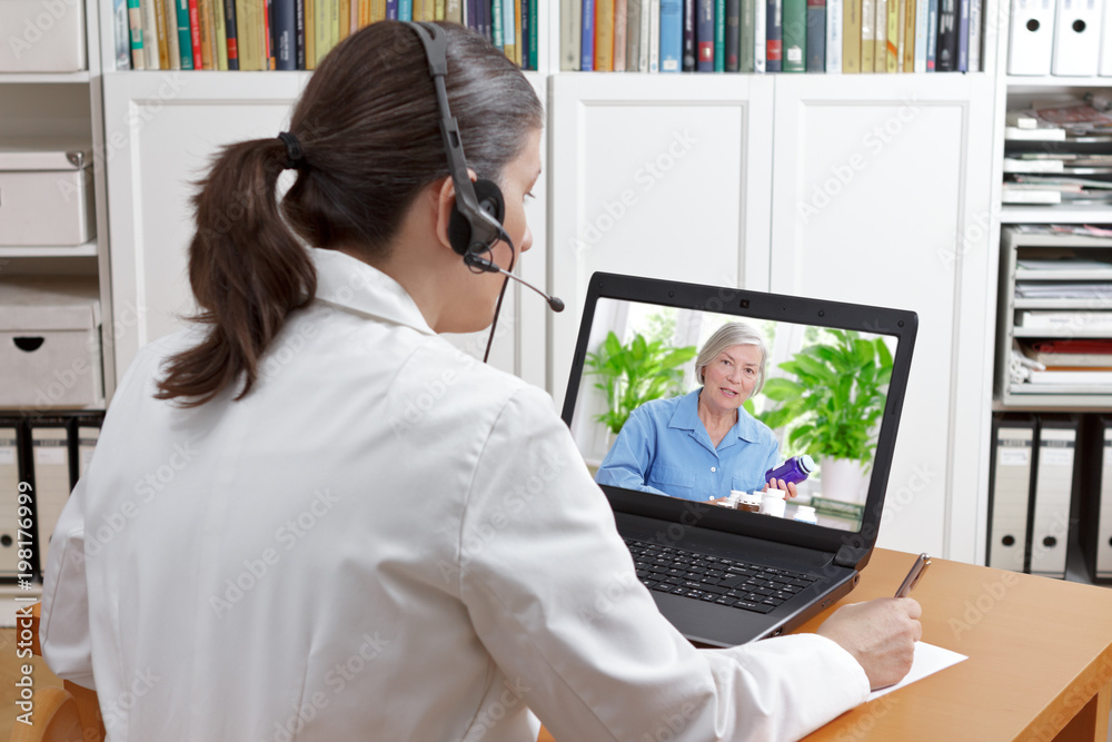 Doctor of geriatrics in her surgery office with headset in front of her laptop during a video call with a senior patient about her prescribed drugs. - obrazy, fototapety, plakaty 