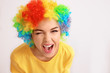 Young woman in funny disguise posing on light background. April fool's day celebration