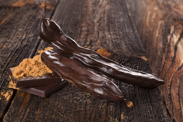 Wall Mural - Carob fruit and carob candy.