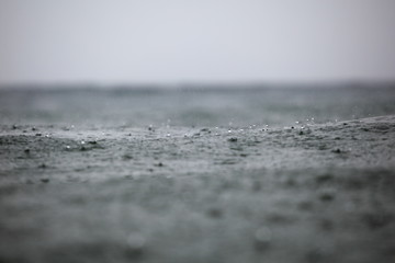 rain drops on the surface of the waves