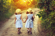 © Ольга Тернавская - Back view of two little girls holding hand and walking together in the park in vintage color tone. Future concept