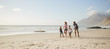 © Monkey Business - Parents Running Along Beach With Children On Summer Vacation