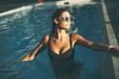 © BGStock72 - Young woman in the outdoor swimming pool