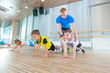© satyrenko - Children at physical education lesson in school gym gymnast kid