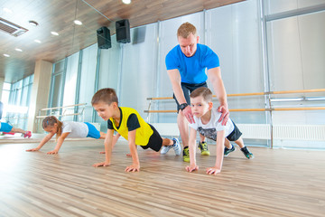 Children at physical education lesson in school gym gymnast kid