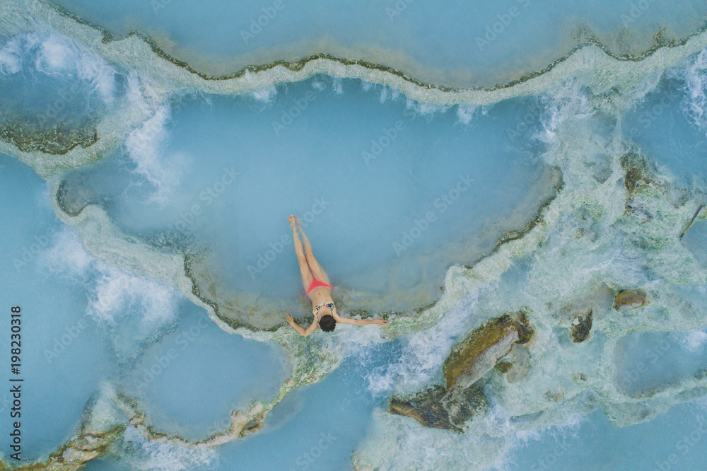 High angle view of girl wearing bikini while relaxing in hot spring