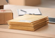 © Africa Studio - Parcel envelopes ready for shipment to client on table in home office
