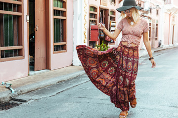boho girl walking on the city street