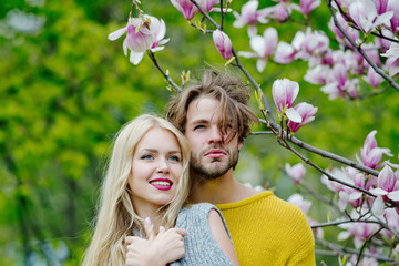 Wall Mural - man and woman, couple in love in spring magnolia flowers