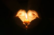 © rdaniluk - Cupped hands with burning candle.