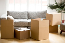 Cardboard Carton Boxes With Personal Belongings Household Stuff In Modern Living Room, Many Packed Containers On Moving Day In New Home, Relocation Or House Removals Delivery Service Concept