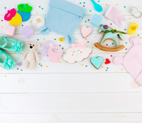 Wall Mural - Baby clothes, gingerbreads and accessories on white wooden background with copy space