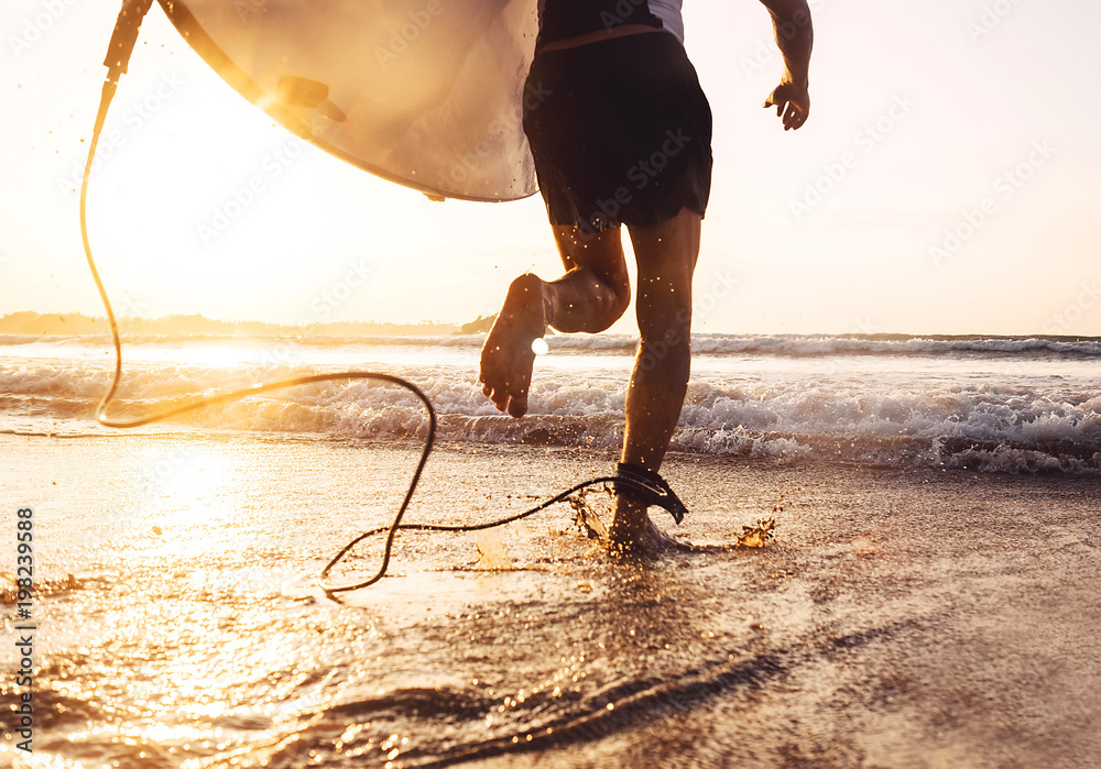 Man surfer run in ocean with surfboard. Active vacation, health lifestyle and sport concept image - obrazy, fototapety, plakaty 