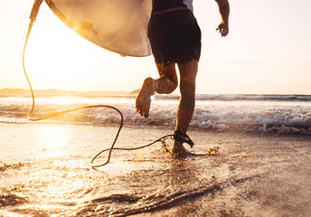 man surfer run in ocean with surfboard. active vacation, health lifestyle and sport concept image