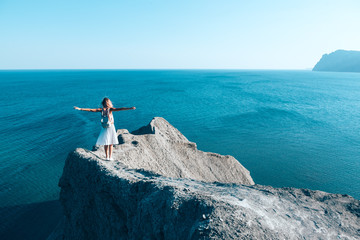 Wall Mural - Girl standing on the mountain top