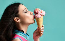 Young Woman In Pink Hat Eat Strawberry Ice-cream Dessert In Waffle Cone On Modern Light Blue 