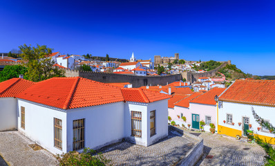 Wall Mural - Panoramic view of the beautiful medieval historic center village of Obidos and Castle of Obidos. Wonderful romantic afternoon landscape at sunny weather. District of Leiria, in the centre of Portugal.