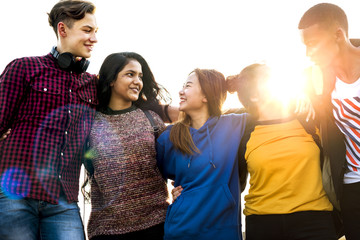 Wall Mural - Group of school friends outdoors arms around one another togetherness and community concept