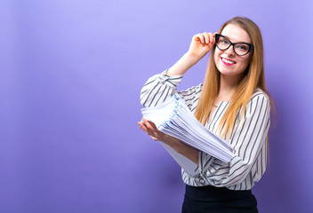 Wall Mural - Office woman with a stack of documents on a solid background