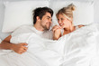 © Tijana - Young loving couple lying on the bed, enjoying
