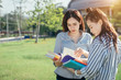 © jumlongch - A group of teenage student in university smiling and reading the book in summer holiday.