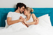 © Tijana - Young loving couple lying on the bed, enjoying