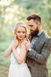 Beautiful young couple. The bearded groom hugging the bride.