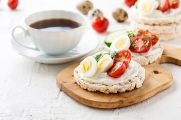 Wall Mural - Open sandwiches of rice cakes with cream cheese , vegetables and quail egg