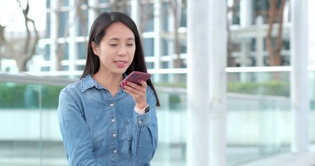 Poster - Woman sending audio message on cellphone at outdoor