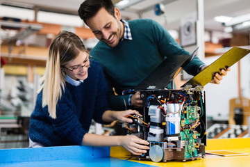 Young students of robotics working on project