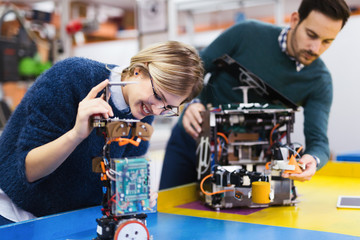 Wall Mural - Young students of robotics working on project