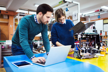 Young students of robotics working on project