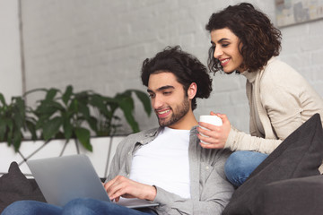 Canvas Print - young couple using laptop at home