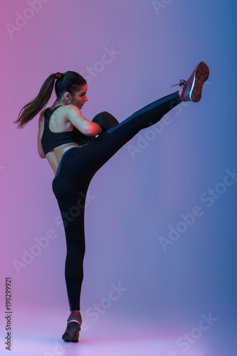 Cuadros en Lienzo Full length portrait of athletic sports woman 20s in tracksuit and black boxing