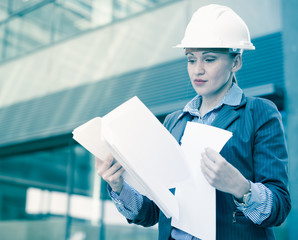 Professional woman in jacket and helmet