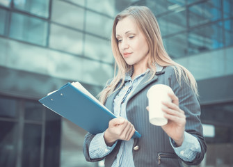 Professional woman in jacket with coffee