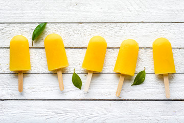 Wall Mural - Refreshing popsicles with orange juice, natural ice lollies, flat lay, top view